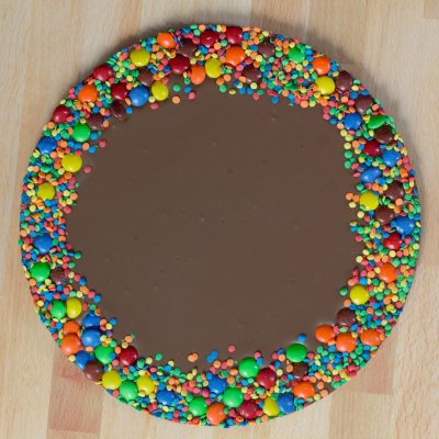 Milk chocolate colorful chocolate gems border blank